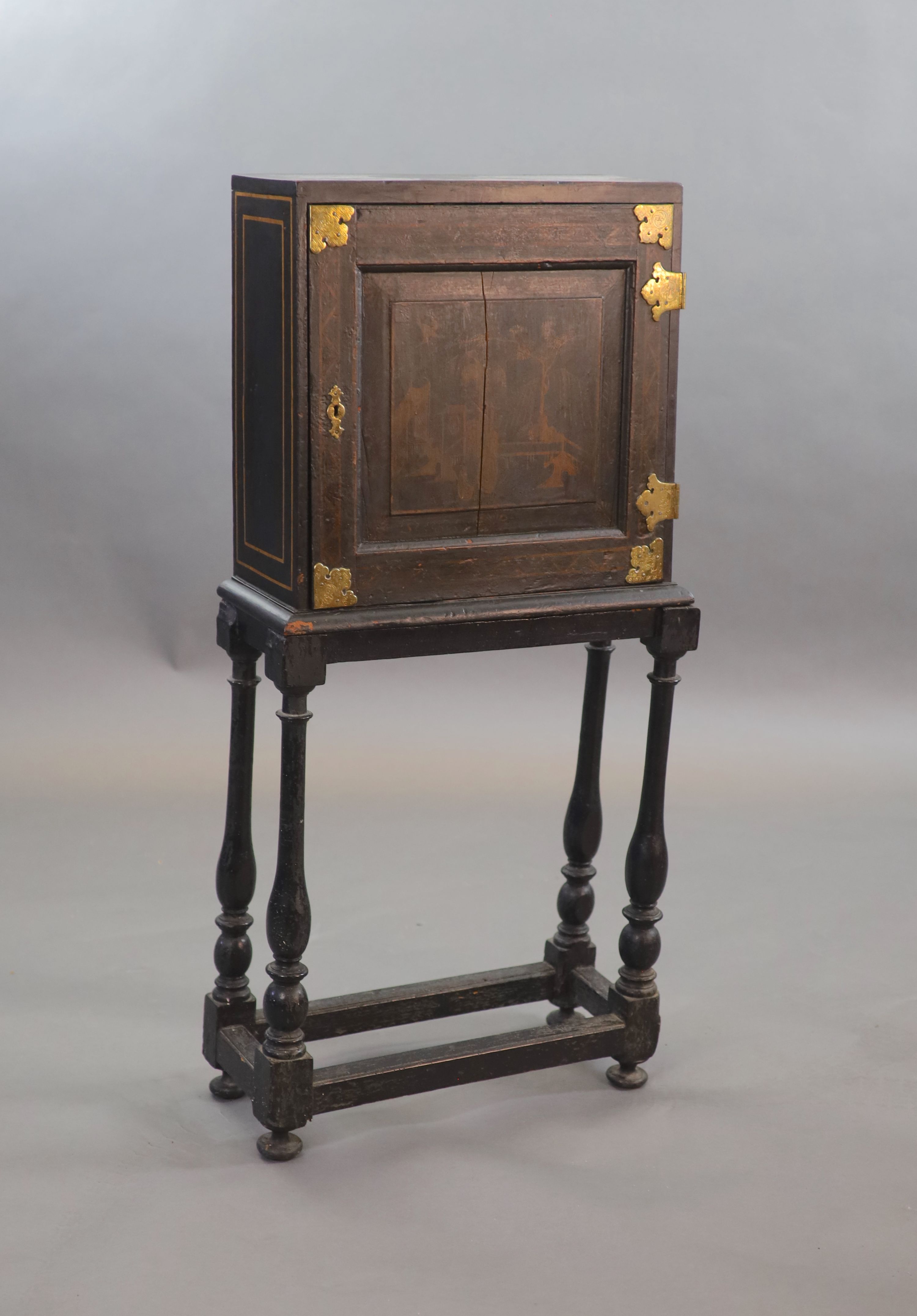 An early 18th century European japanned cabinet on stand, W.54cm D.24cm H.115.5cm